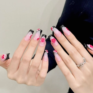Handmade black French tip press-on nails with 3D floral carving and pink gradient