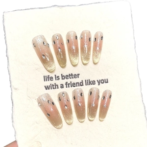Sparkling gradient cat-eye press-on nails with glitter, stars, and rhinestones in almond shape