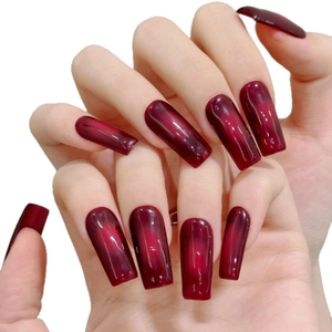 Deep red gradient cat-eye long coffin press-on nails with shiny finish on white background