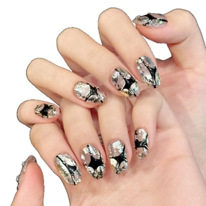 Silver glitter cat-eye press-on nails with black starburst and foil flakes on oval shape