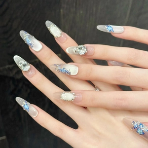Blue floral almond press-on nails with silver cat-eye finish and 3D rhinestone accents