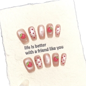Handmade strawberry cat eye press-on nails with 3D accents and red polka dot patterns