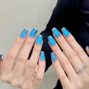 Royal blue cat eye press-on nails with silver glitter edges and a glossy square finish