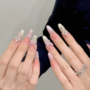 Dreamy 3D butterfly press-on nails with pink cat-eye glitter and pearl floral accents