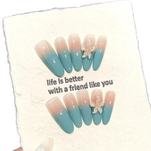Handmade almond press-on nails with mint green ombre design and 3D floral accents