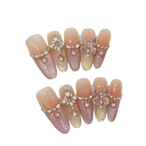Pink cat eye press-on nails with 3D crystal flowers and purple butterfly accents