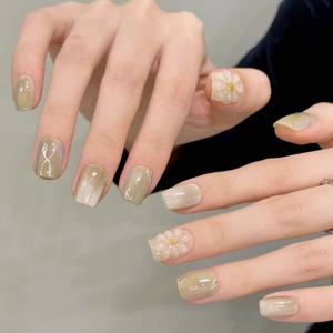 Olive green cat-eye press-on nails with 3D white daisy floral relief and gold foil accents