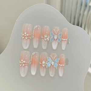 Handmade cat eye press-on nails with 3D blue butterflies and pearl rhinestone details