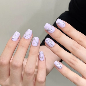 Short lavender matte press-on nails with silver 3D relief lines and white pearl accents
