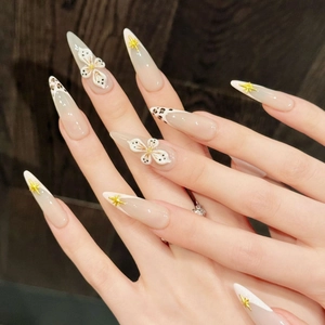 French leopard print stiletto press-on nails with 3D white flowers and gold charms