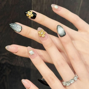 Bronze floral cat eye press-on nails set with vintage flower ring on dark wood
