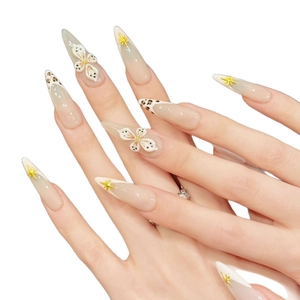 French tip almond press-on nails with leopard print, 3D white flowers, and gold stars