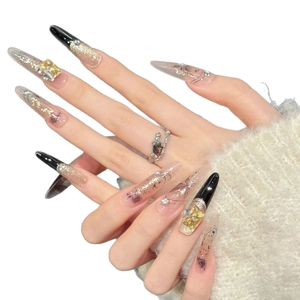 Extra long amber cat eye press-on nails with black tips and luxury 3D diamond accents