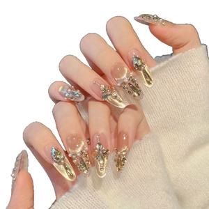 Faux ongles faits main œil de chat champagne avec cristaux de luxe et perles