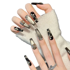 Sparkling cat-eye press-on nails with silver glitter, pearls and rhinestone bow design