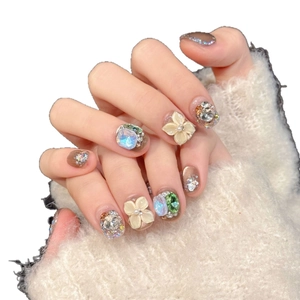 Handmade cat eye press-on nails with 3D floral carvings and sparkling rhinestones