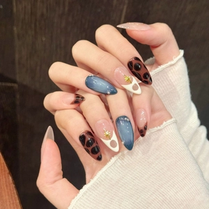 Handmade almond press-on nails with leopard print, blue cat-eye effect and gold accents
