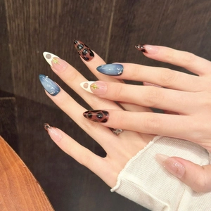 Blue marble and leopard print almond press-on nails with pearls and gold star accents