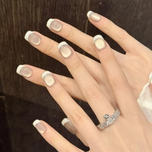 Short french cat-eye press-on nails in nude pink with white tips and Saturn ring