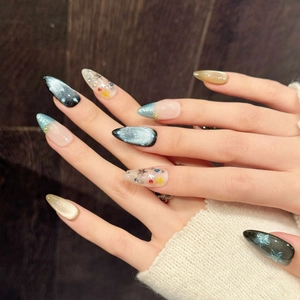 Handmade cat eye press-on nails with star sequins and floral 3D accents on almond shape