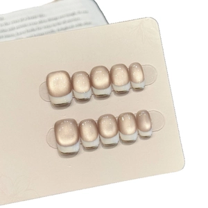 Short square champagne cat-eye press-on nails with white French tips and gold trim