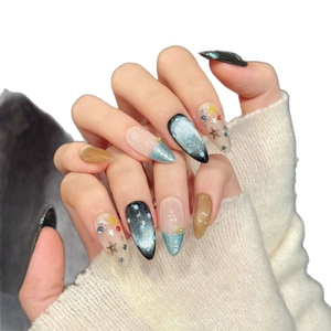 Handmade almond press-on nails featuring starry cat-eye design and star accents