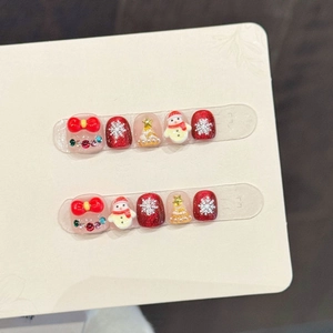 Cute Christmas themed 3D press-on nails for girls with red bows and snowman designs