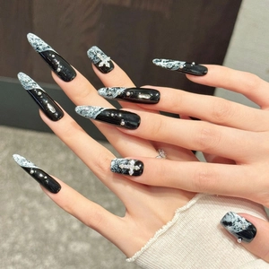 Handmade black and white marble stiletto press-on nails with silver gothic cross charms