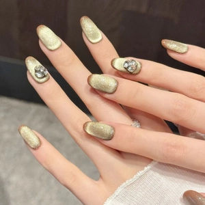 Cat eye press-on nails in champagne gold with 3D heart rhinestones and glossy finish