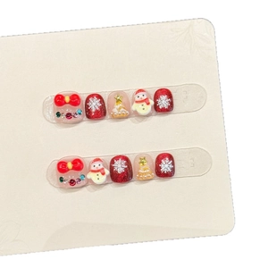 Kids Christmas press-on nails set with 3D snowman, tree and bow designs on 10 tips