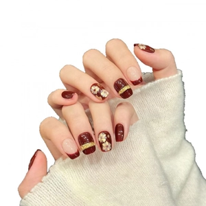Retro deep red press-on nails with golden glitter flowers and relief accents