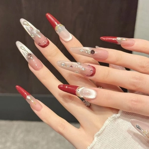 Extra long stiletto press-on nails in burgundy cat-eye style with 3D crystal rhinestones