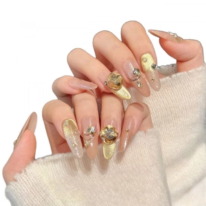 Champagne cat eye press-on nails with luxury rhinestones and almond shape design