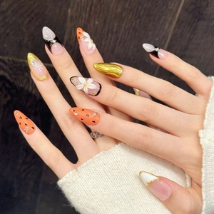 Artistic press-on nails with 3D floral designs and orange heart patterns in almond shape