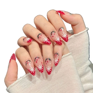 Handmade Christmas press-on nails with red almond tips, white snowflakes and berry designs