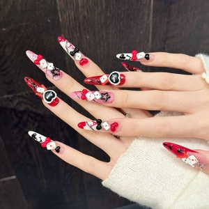 3D Poker themed press-on nails with red bows and heart patterns on dark background