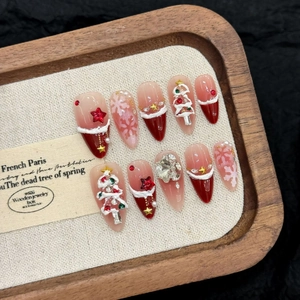 Christmas press-on nails featuring red velvet, snowflake patterns and rhinestones