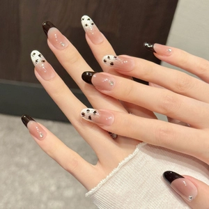 French leopard cat-eye press-on nails with black hearts and glitter rhinestone accents
