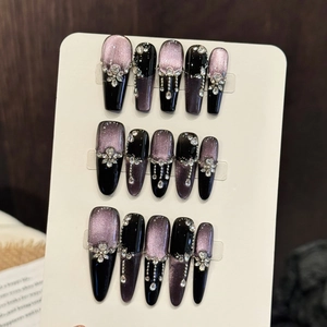 Handmade purple cat-eye press-on nails with sparkling rhinestones and floral charms