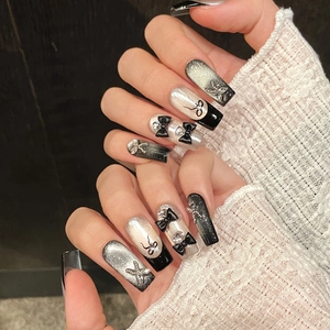 Handmade black cat eye press-on nails with 3D bows and rhinestones in long coffin shape