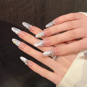 Blue cat eye press-on nails with 3D floral accents and pearls in almond shape