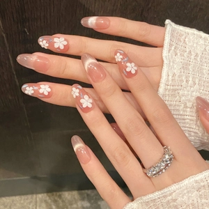 Cat eye press-on nails with 3D floral accents and almond shape in soft pink