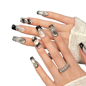 Handmade black cat-eye press-on nails with 3D bows, silver butterfly and zircon accents