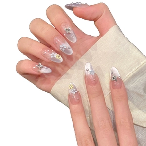 Pink gradient almond press-on nails with blue and yellow flowers, pearls and rhinestones