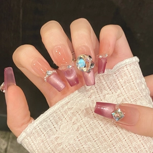 Detail of luxury purple cat-eye press-on nails with 3D aurora rhinestones and pearls