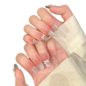 Pink cat eye french press-on nails with 3D white bowknot and sparkling rhinestones