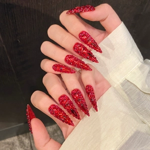 Handmade red stiletto press-on nails with full crystal rhinestones for a luxury finish