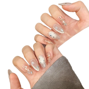 Star and moon press-on nails with silver cat-eye effect and gold glitter star sequins