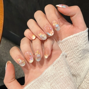 Unghie finte fatte a mano effetto cat eye con fiori a olio e finitura glitter oro