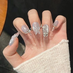 Long coffin cat-eye press-on nails with 3D butterfly charms and rhinestone accents